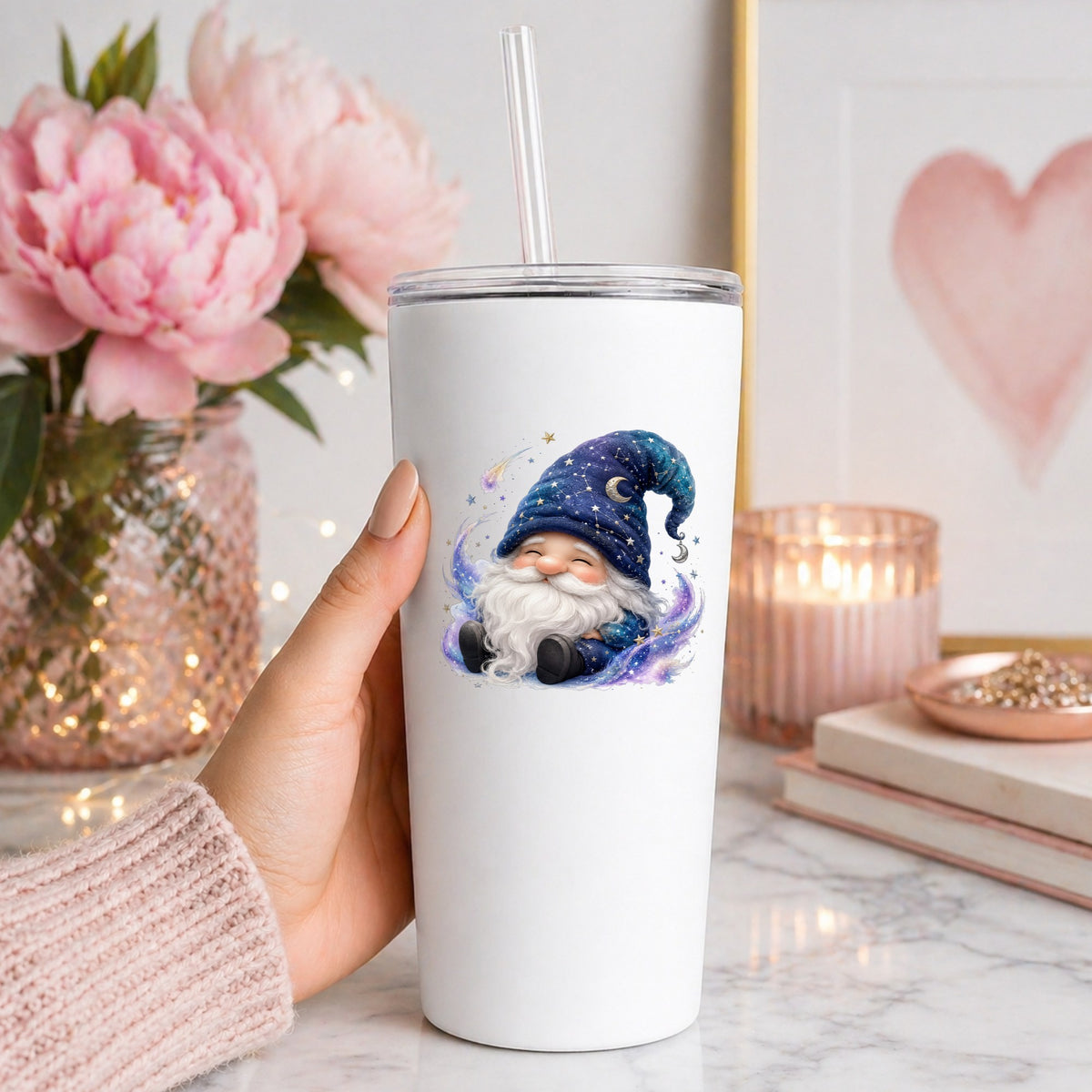 Celestial Starry Night Gnome UV DTF sticker applied to a white straw tumbler beside pink peonies