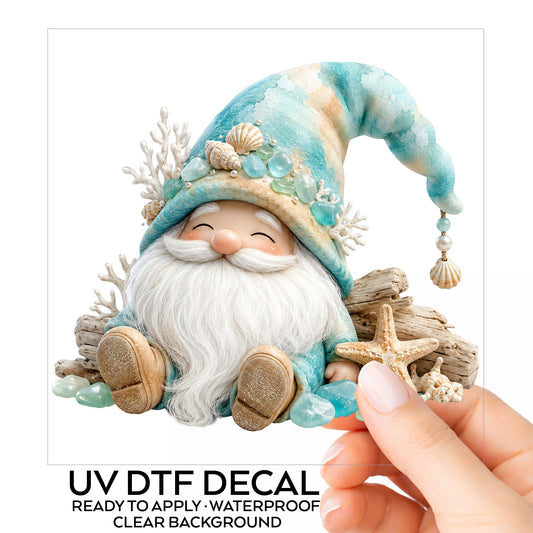 Beach Gnome With Seashells UV DTF sticker on its backing card, held in hand