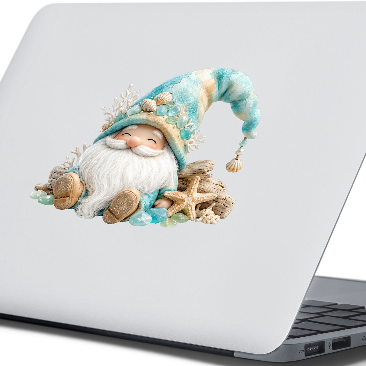 Beach Gnome With Seashells UV DTF sticker applied to the lid of a silver laptop
