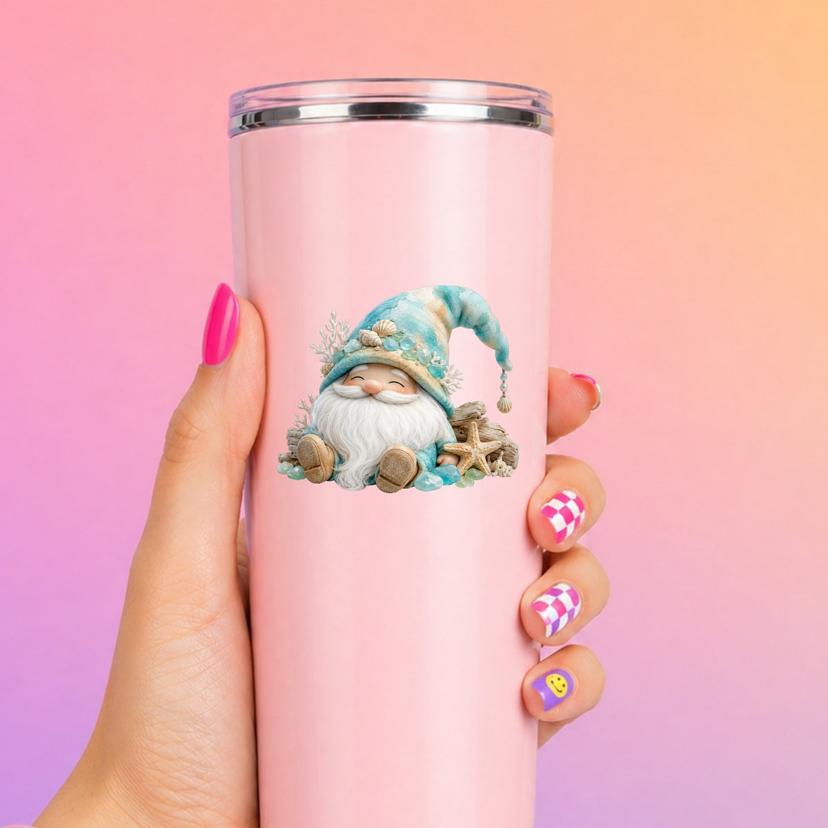 Beach Gnome With Seashells UV DTF sticker applied to a tall pink tumbler on a pink and orange background
