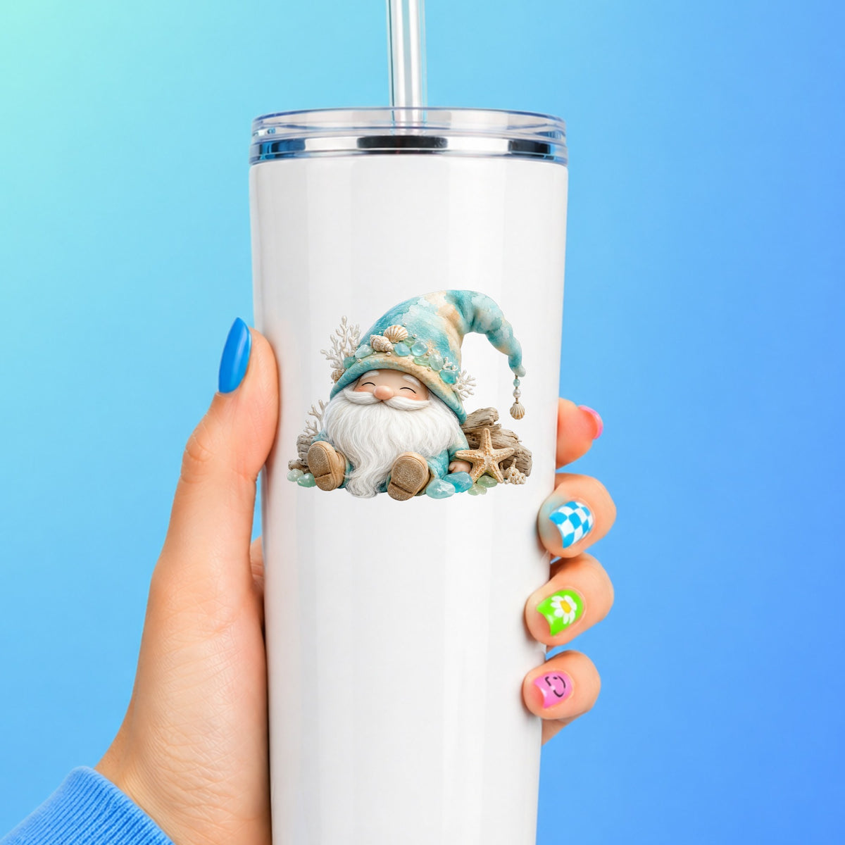 Beach Gnome With Seashells UV DTF sticker applied to a white straw tumbler on a blue background