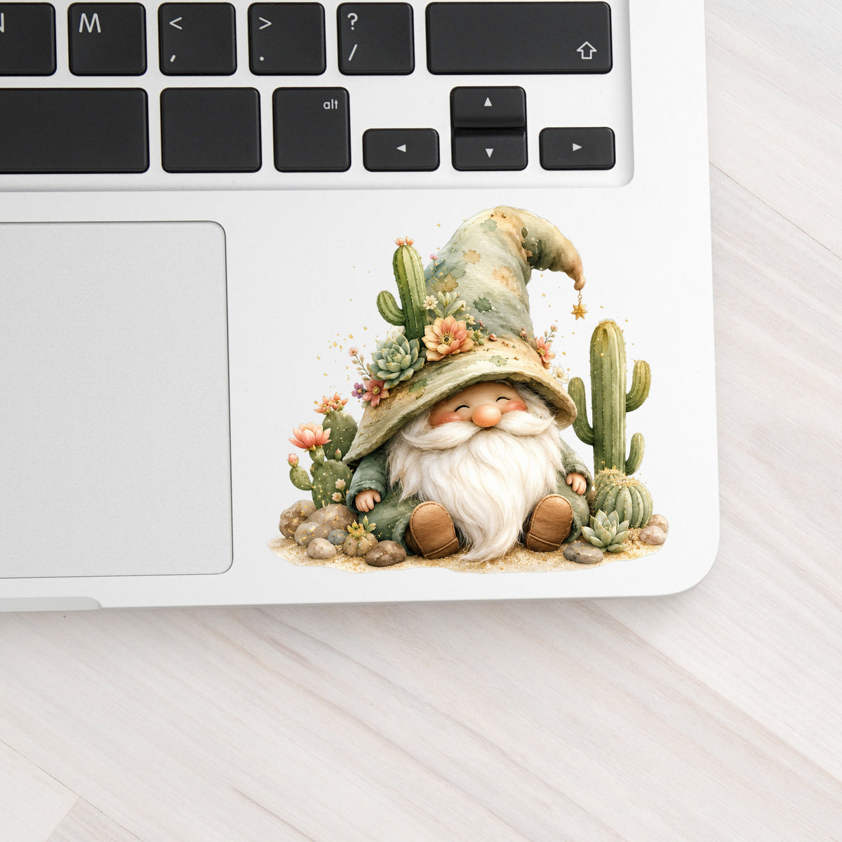 Cactus Succulent Gnome UV DTF sticker applied to a silver laptop beside the keyboard