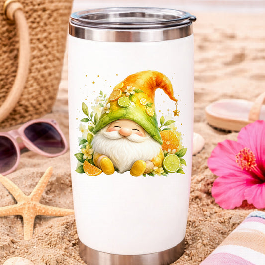 Citrus Gnome With Orange Slices UV DTF sticker applied to a white travel tumbler on beach sand