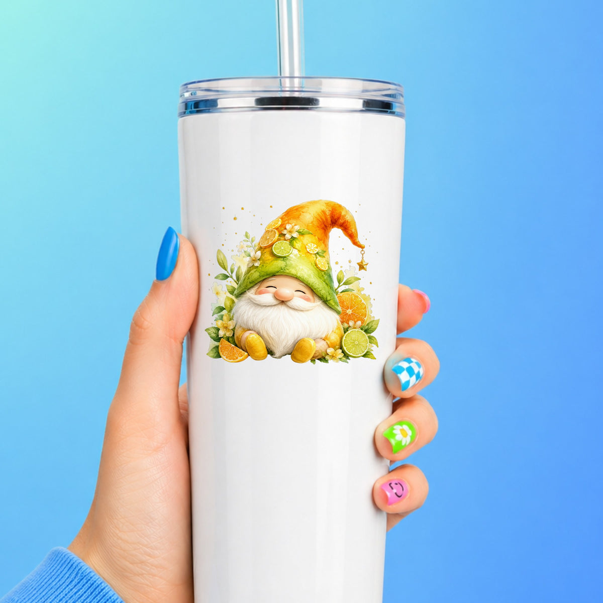 Citrus Gnome With Orange Slices UV DTF sticker applied to a white straw tumbler on a blue background