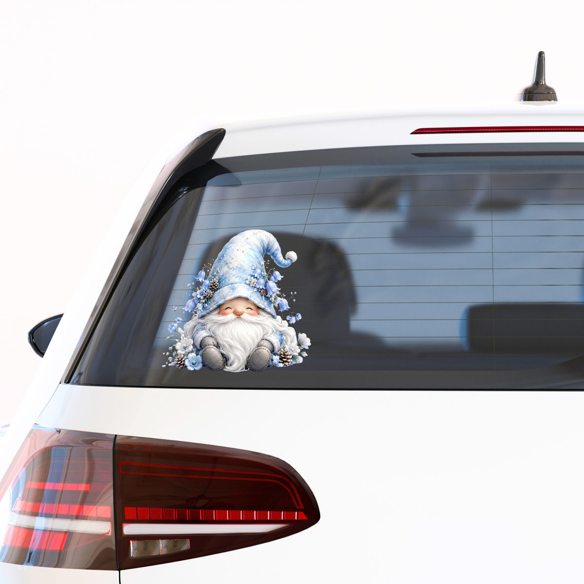 Winter Gnome With Pinecones UV DTF sticker applied to the rear window of a white car