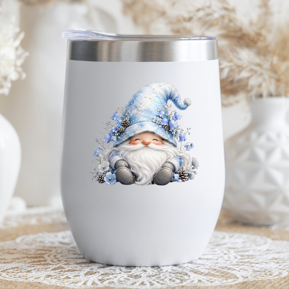 Winter Gnome With Pinecones UV DTF sticker applied to a white stemless tumbler with a lid