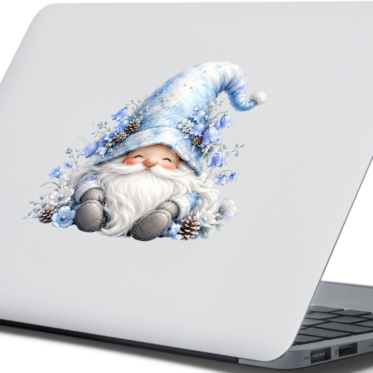 Winter Gnome With Pinecones UV DTF sticker applied to the lid of a silver laptop