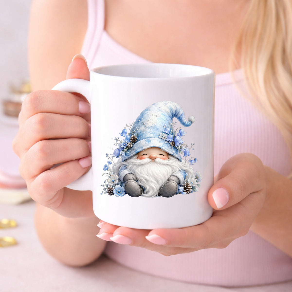 Winter Gnome With Pinecones UV DTF sticker applied to a white coffee mug held in both hands