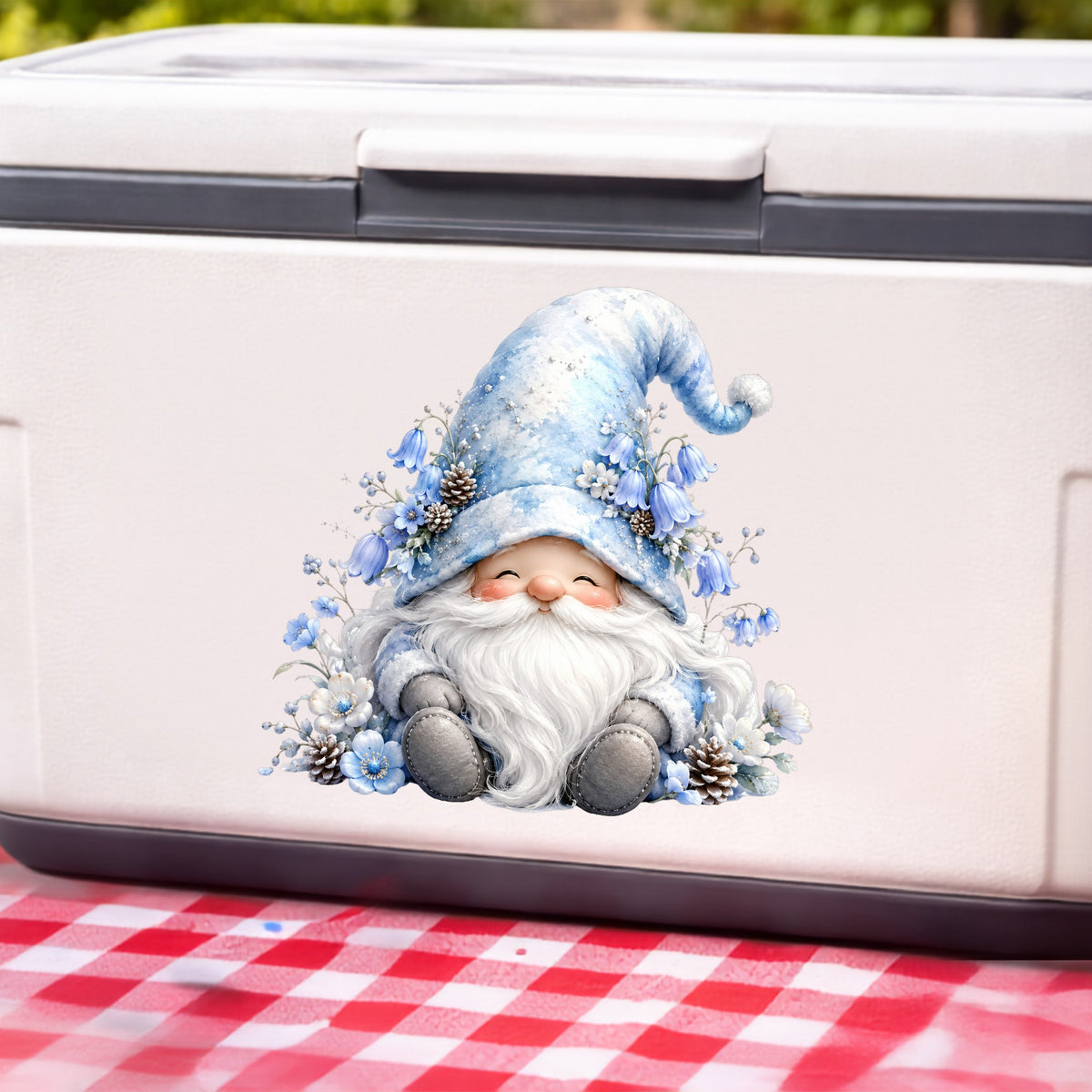Winter Gnome With Pinecones UV DTF sticker applied to a white cooler on a red gingham cloth