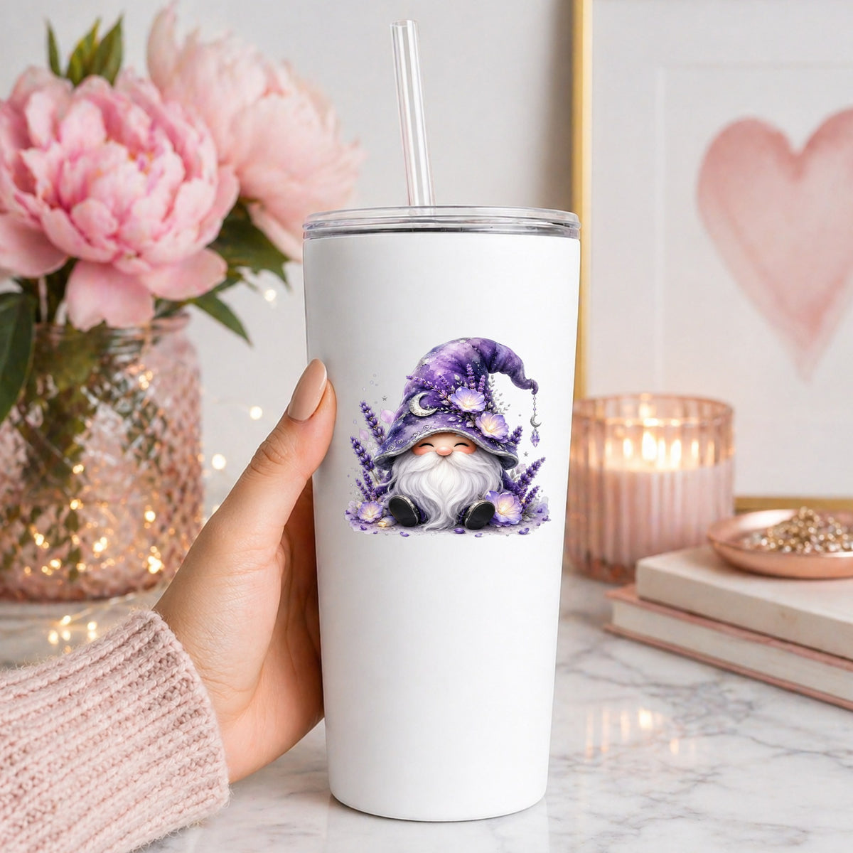 Lavender Gnome With Moon Charm UV DTF sticker applied to a white straw tumbler beside pink peonies