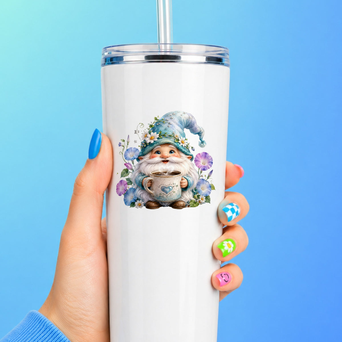 Gnome Holding Coffee Mug UV DTF sticker applied to a white straw tumbler on a blue background