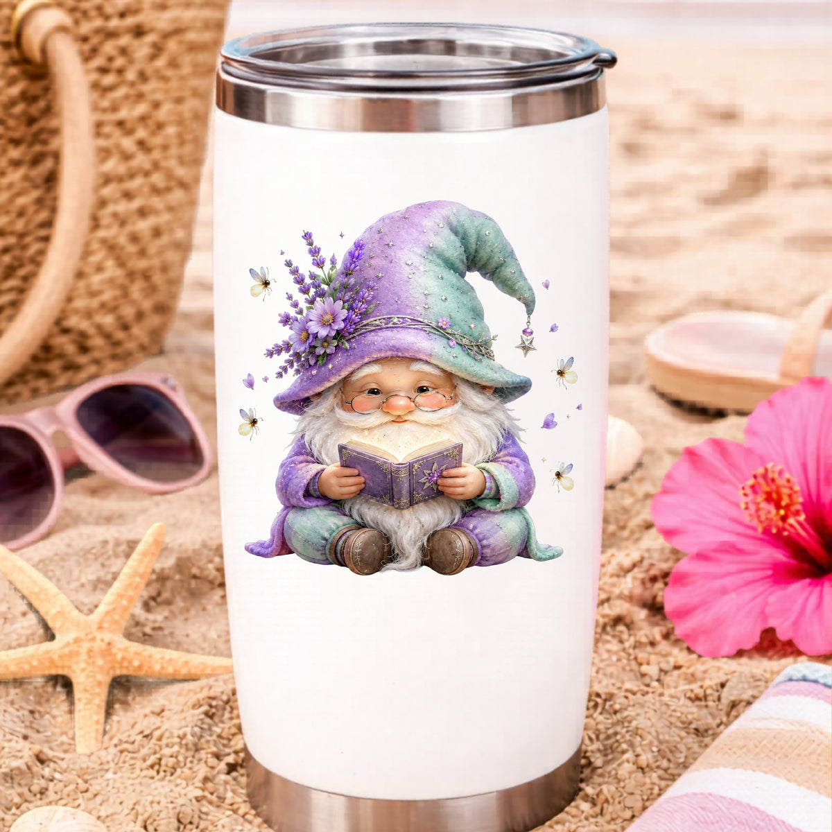 Lavender Reading Gnome With Fireflies UV DTF sticker applied to a white travel tumbler on beach sand
