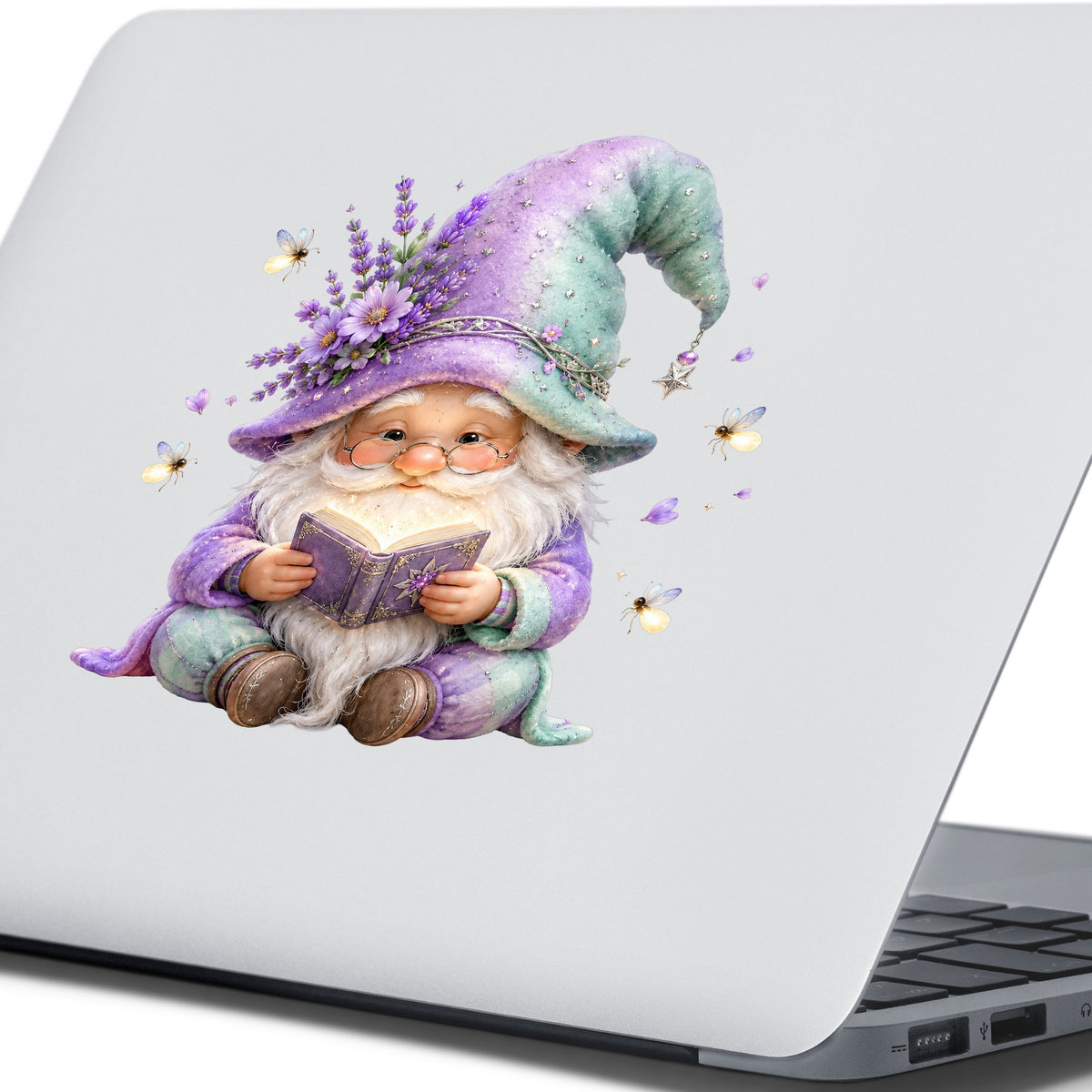 Lavender Reading Gnome With Fireflies UV DTF sticker applied to the lid of a silver laptop