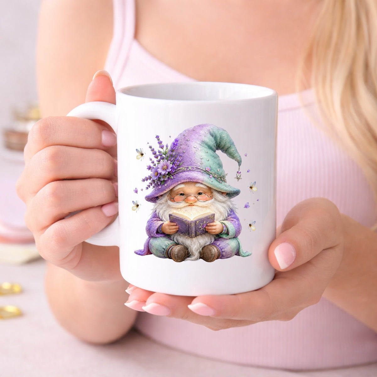 Lavender Reading Gnome With Fireflies UV DTF sticker applied to a white coffee mug held in both hands
