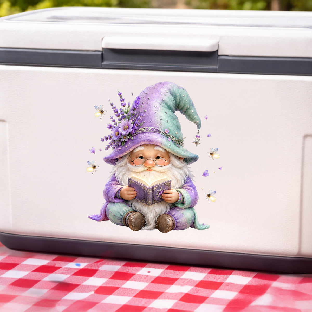 Lavender Reading Gnome With Fireflies UV DTF sticker applied to a white cooler on a red gingham cloth