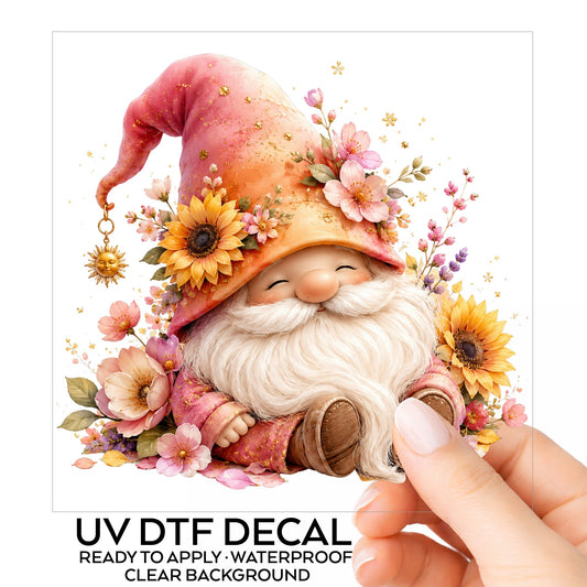 Sunflower Gnome With Pink Flowers UV DTF sticker on its backing card, held in hand
