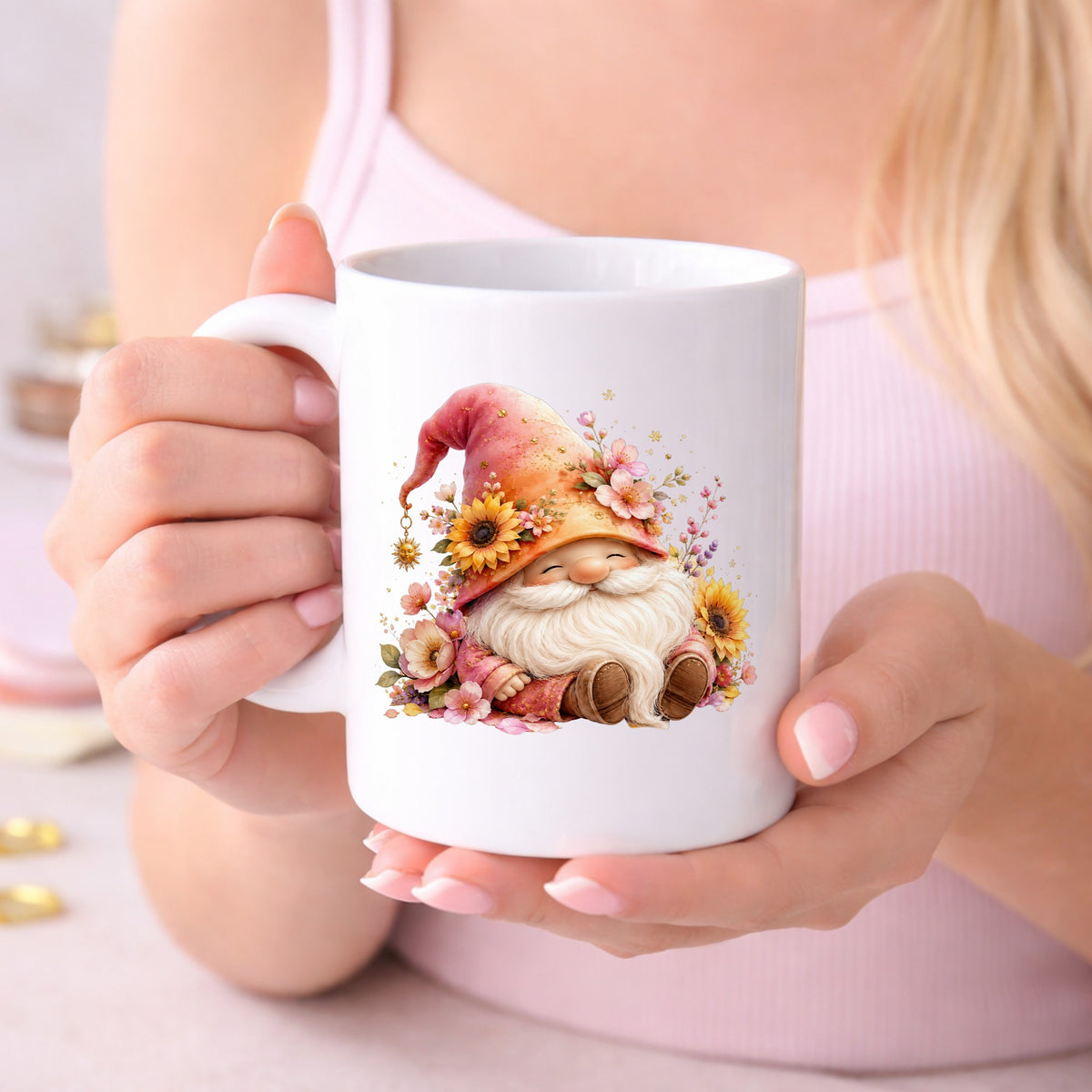 Sunflower Gnome With Pink Flowers UV DTF sticker applied to a white coffee mug held in both hands
