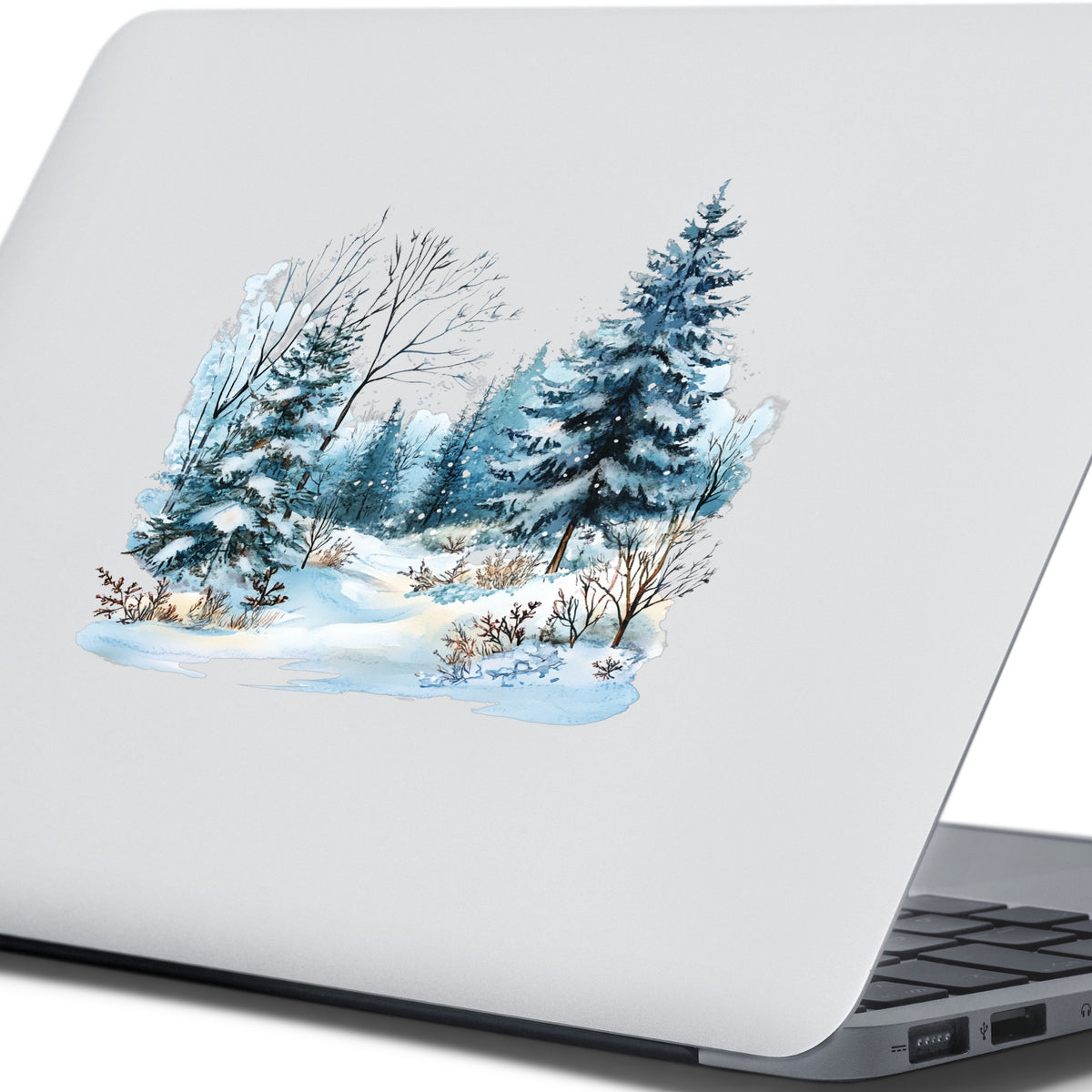 Snowy Pine Forest UV DTF sticker applied to a laptop