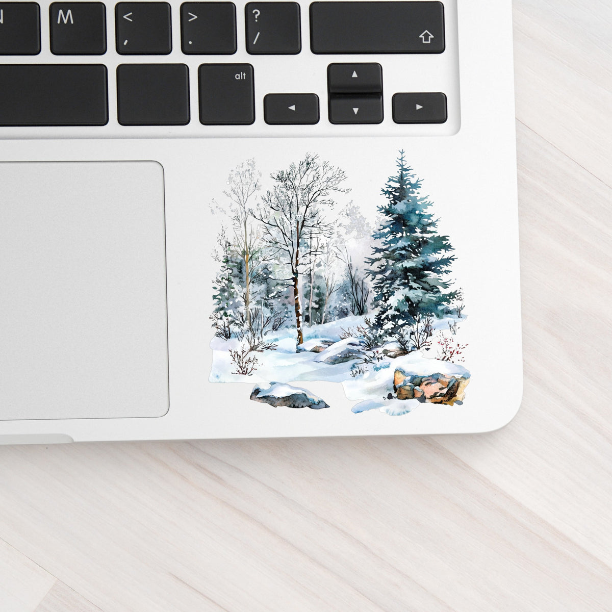 Birch And Spruce Winter Forest UV DTF sticker applied to a laptop beside the keyboard