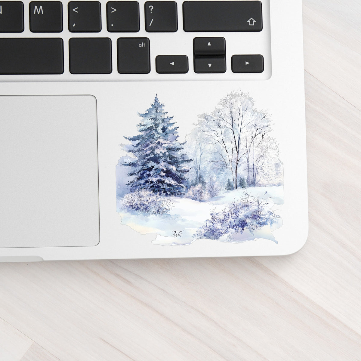 Purple Winter Forest UV DTF sticker applied to a laptop beside the keyboard