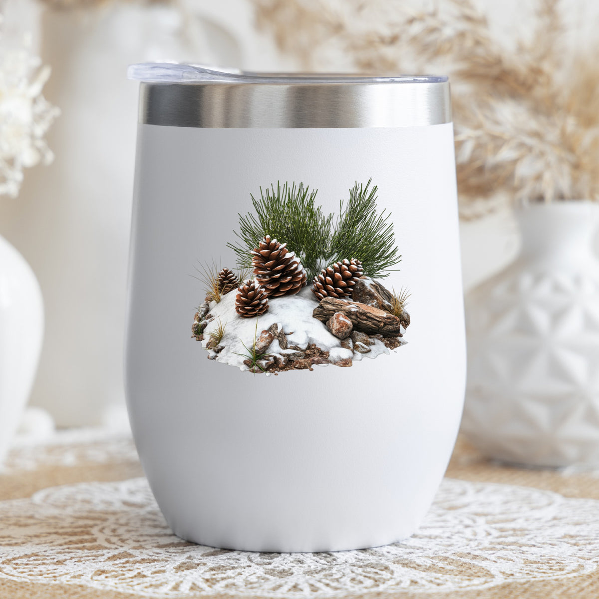 Pine Cones In Snow UV DTF sticker applied to a stemless wine glass
