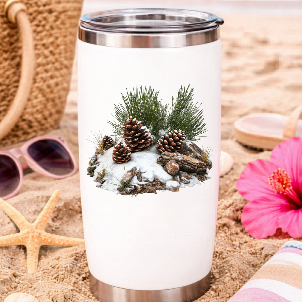 Pine Cones In Snow UV DTF sticker applied to a water bottle at the beach