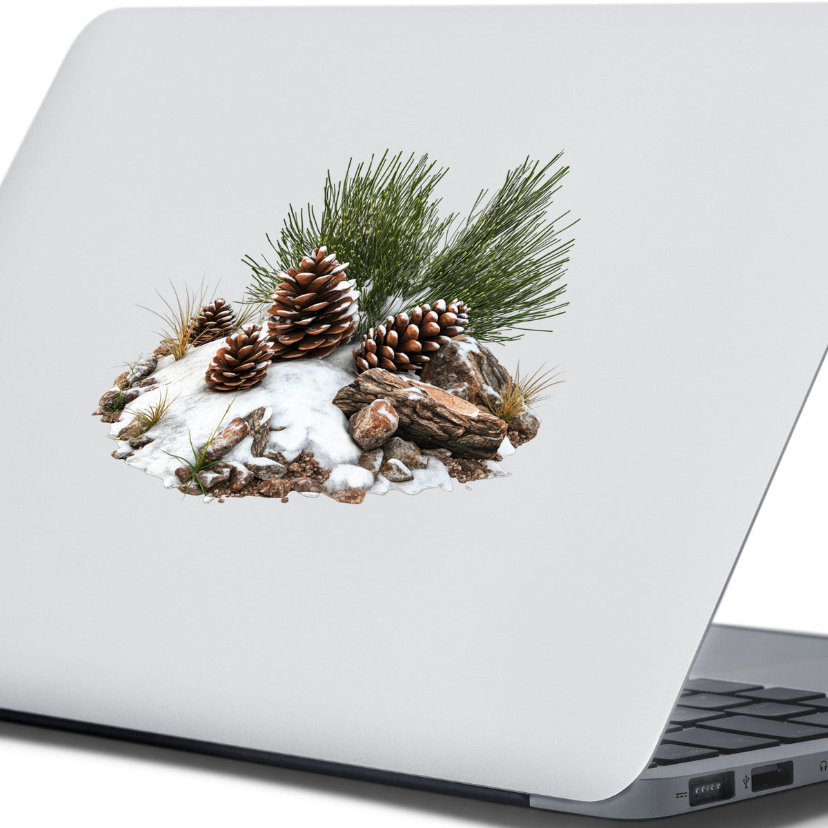 Pine Cones In Snow UV DTF sticker applied to a laptop