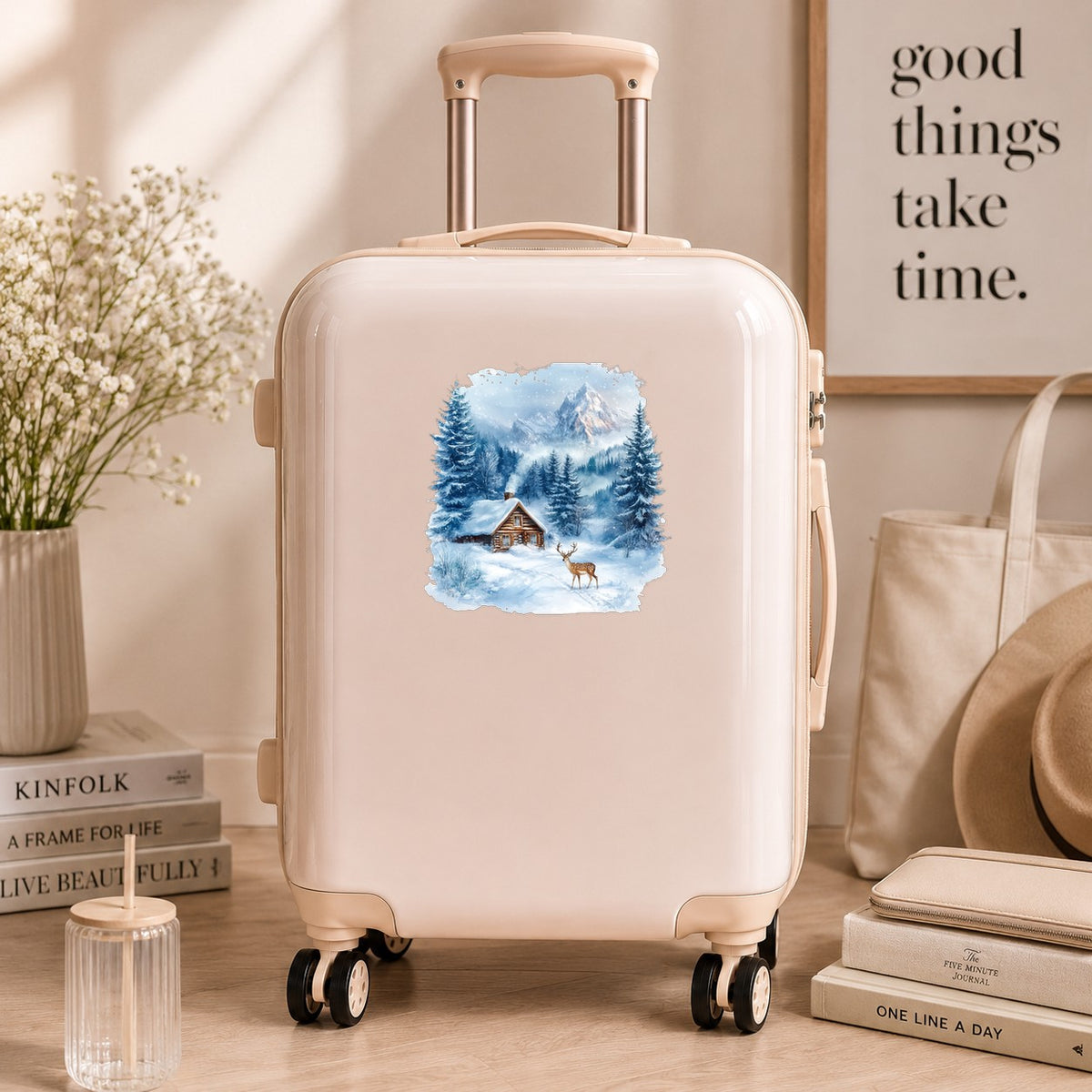 Blue Winter Cabin With Deer UV DTF sticker applied to a neutral suitcase