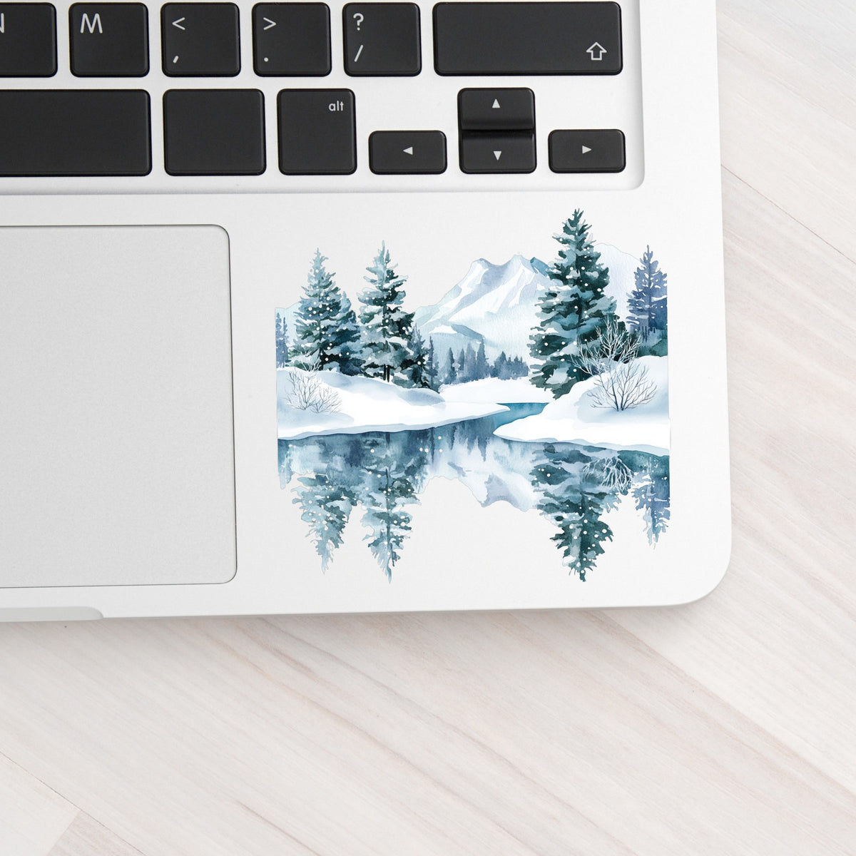 Winter Lake Reflection UV DTF sticker applied to a laptop beside the keyboard