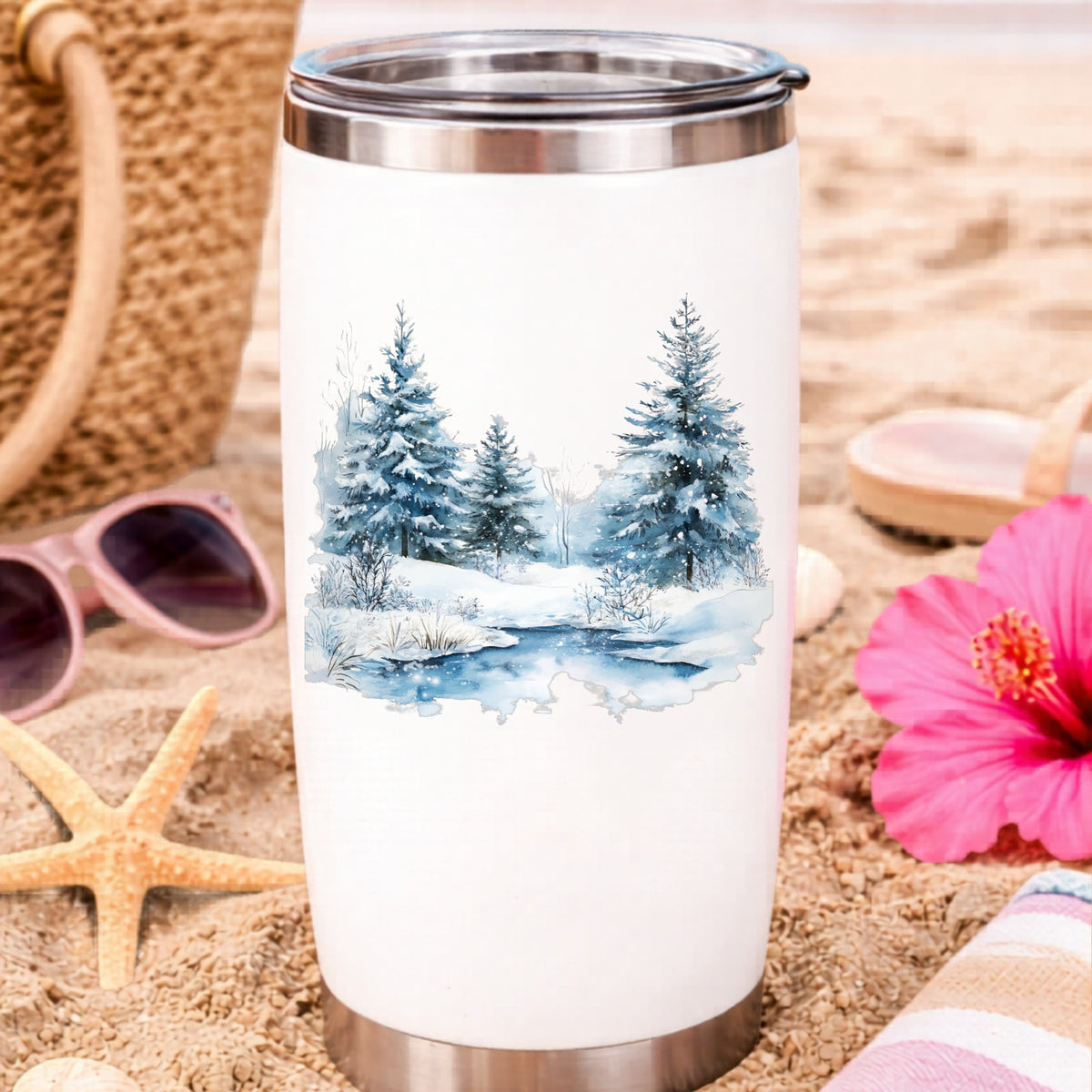 Snowy Evergreens By Stream UV DTF sticker applied to a water bottle at the beach
