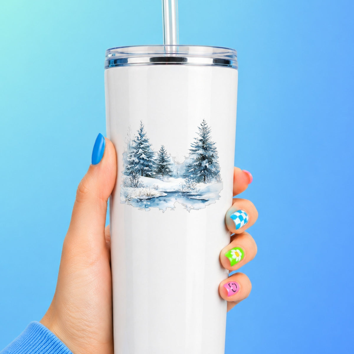Snowy Evergreens By Stream UV DTF sticker applied to a white tumbler