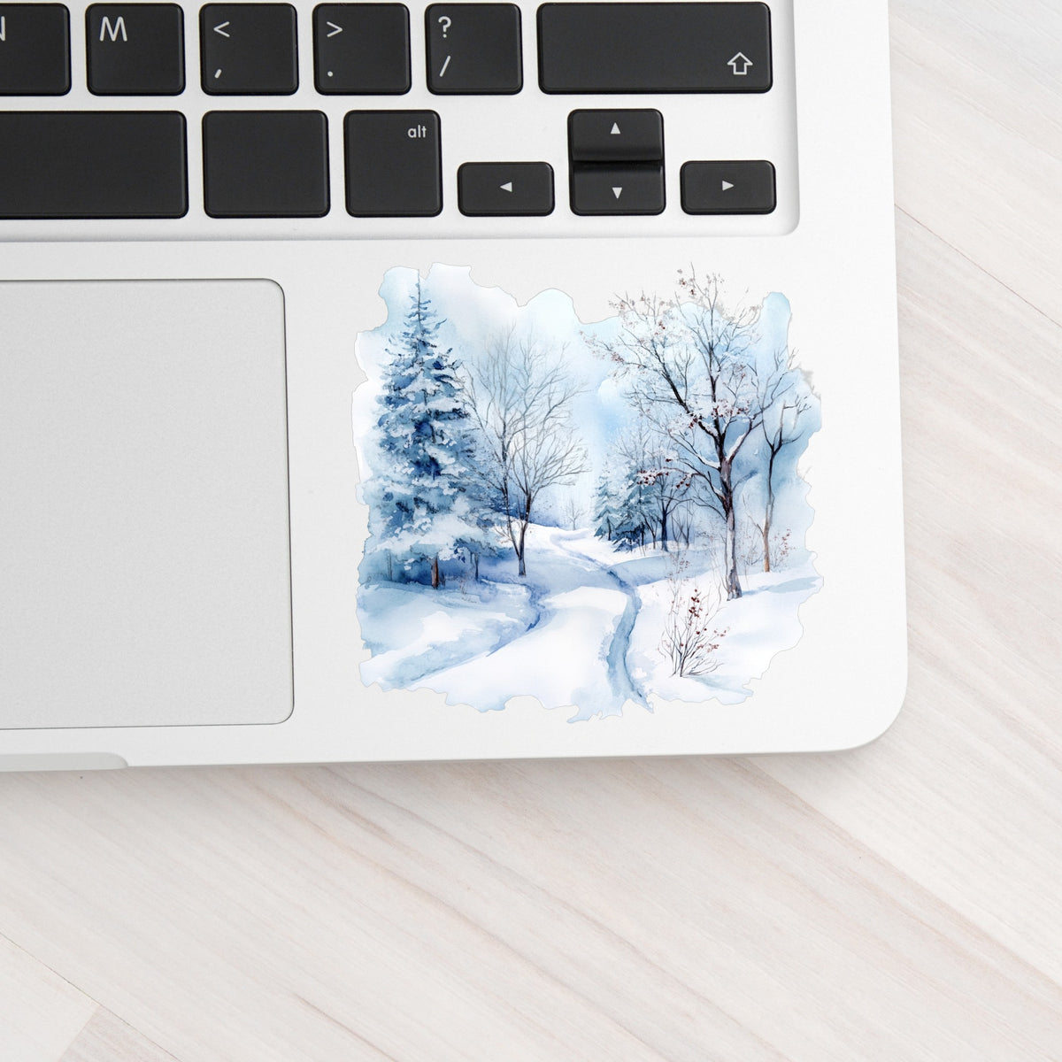 Winter Snow Path UV DTF sticker applied to a laptop beside the keyboard