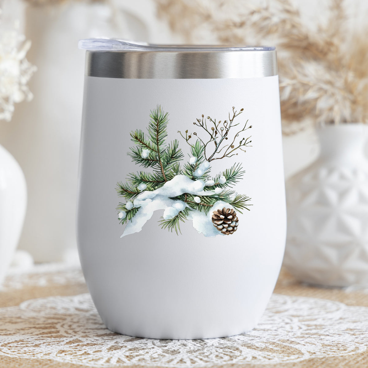 Snowy Pine Branch With Pine Cone UV DTF sticker applied to a stemless wine glass