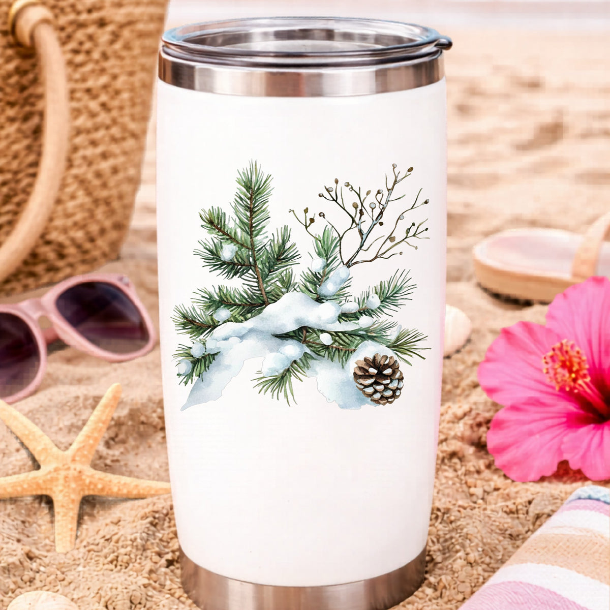 Snowy Pine Branch With Pine Cone UV DTF sticker applied to a water bottle at the beach