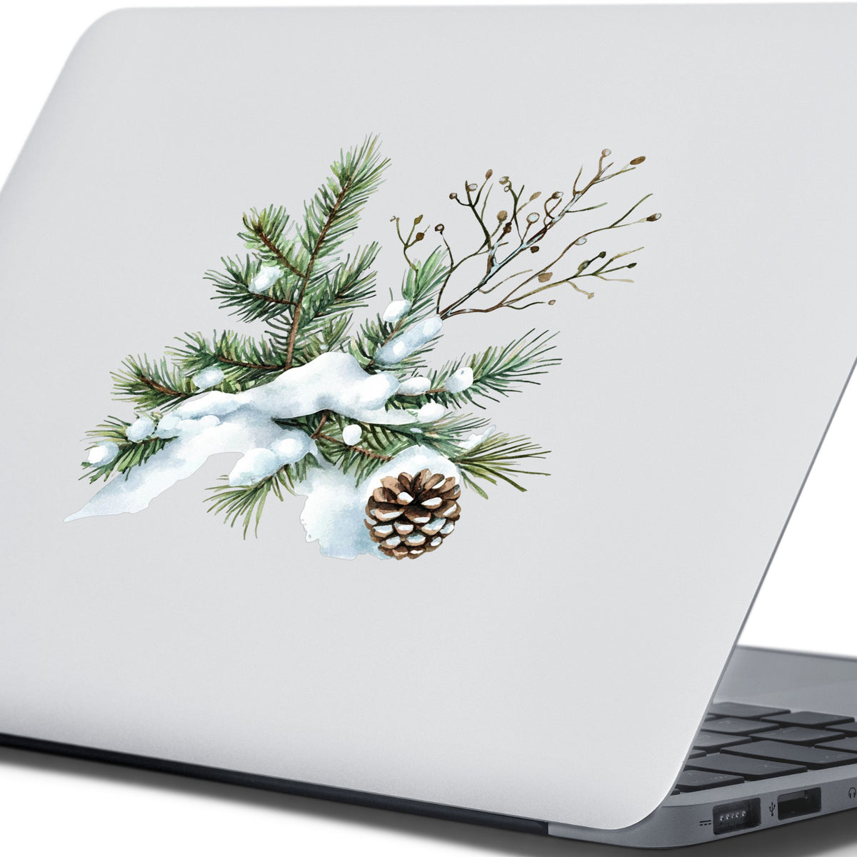 Snowy Pine Branch With Pine Cone UV DTF sticker applied to a laptop