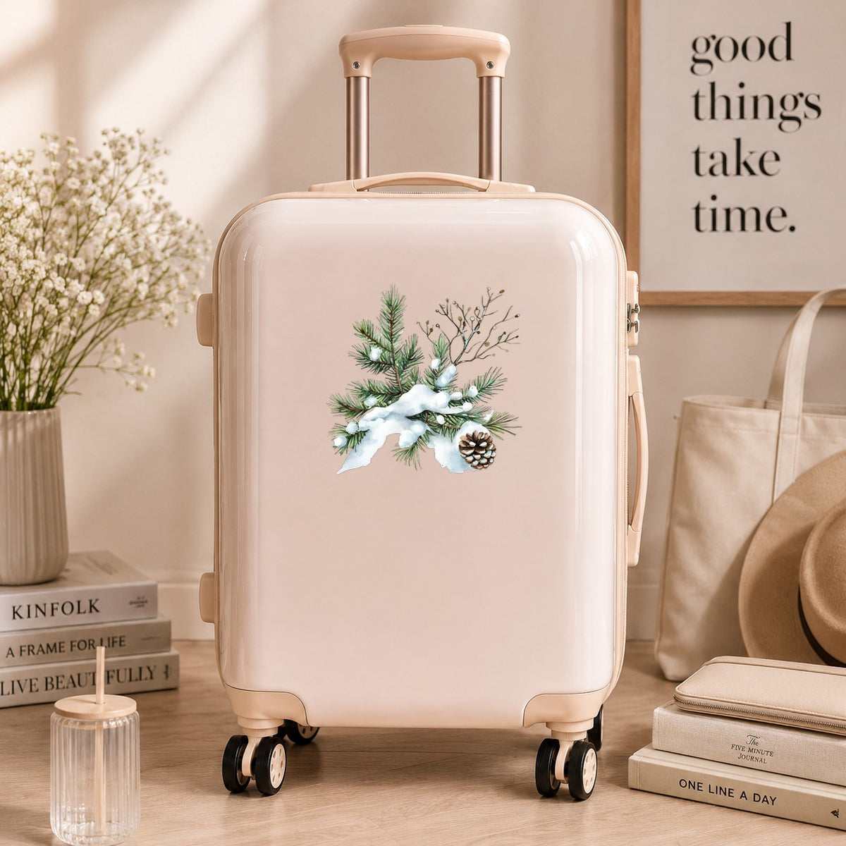 Snowy Pine Branch With Pine Cone UV DTF sticker applied to a neutral suitcase