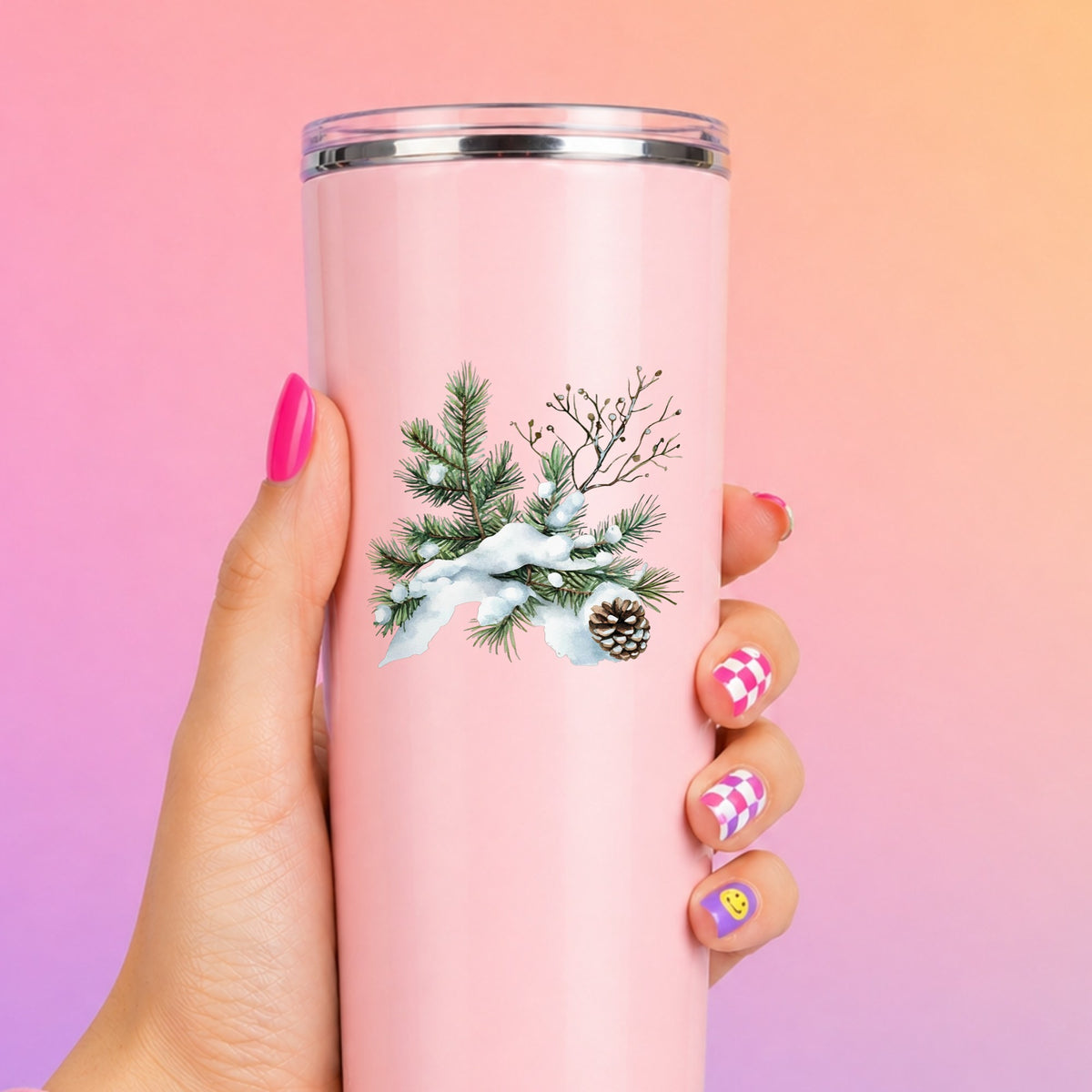 Snowy Pine Branch With Pine Cone UV DTF sticker applied to a pink tumbler
