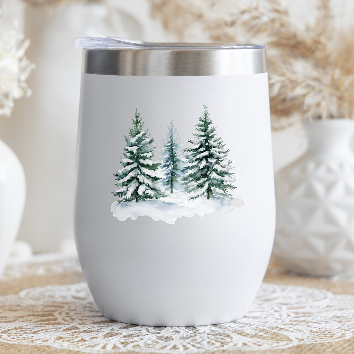 Three Snowy Pine Trees UV DTF sticker applied to a stemless wine glass