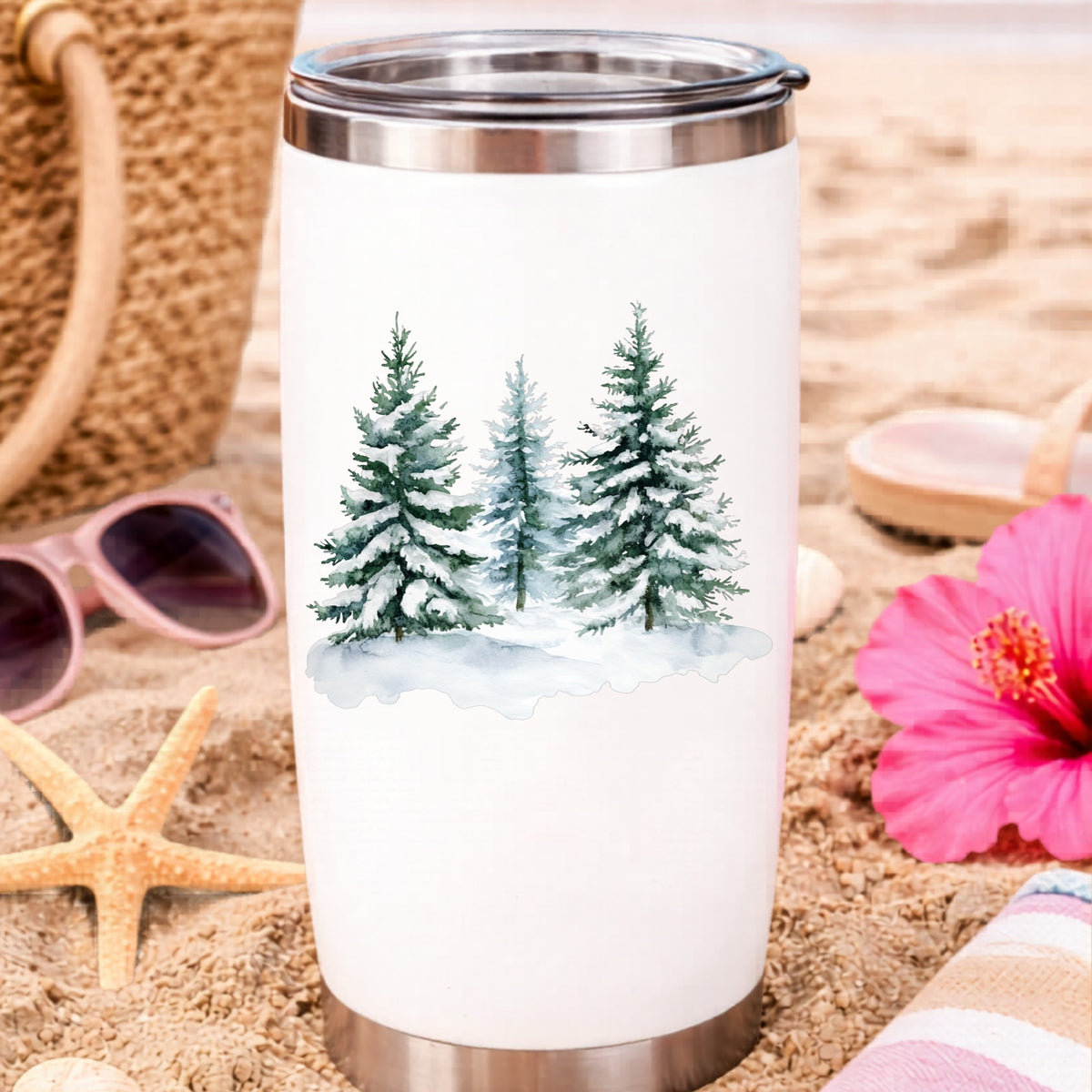 Three Snowy Pine Trees UV DTF sticker applied to a water bottle at the beach