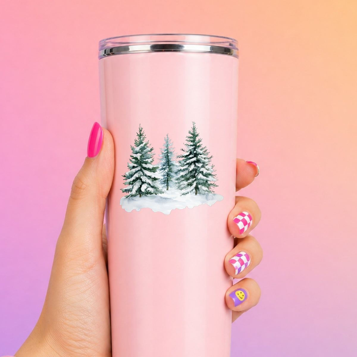 Three Snowy Pine Trees UV DTF sticker applied to a pink tumbler