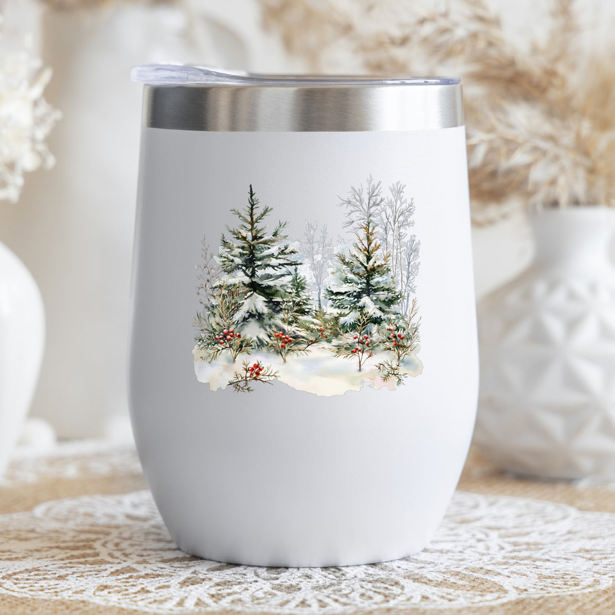 Winter Pine Trees With Berries UV DTF sticker applied to a stemless wine glass