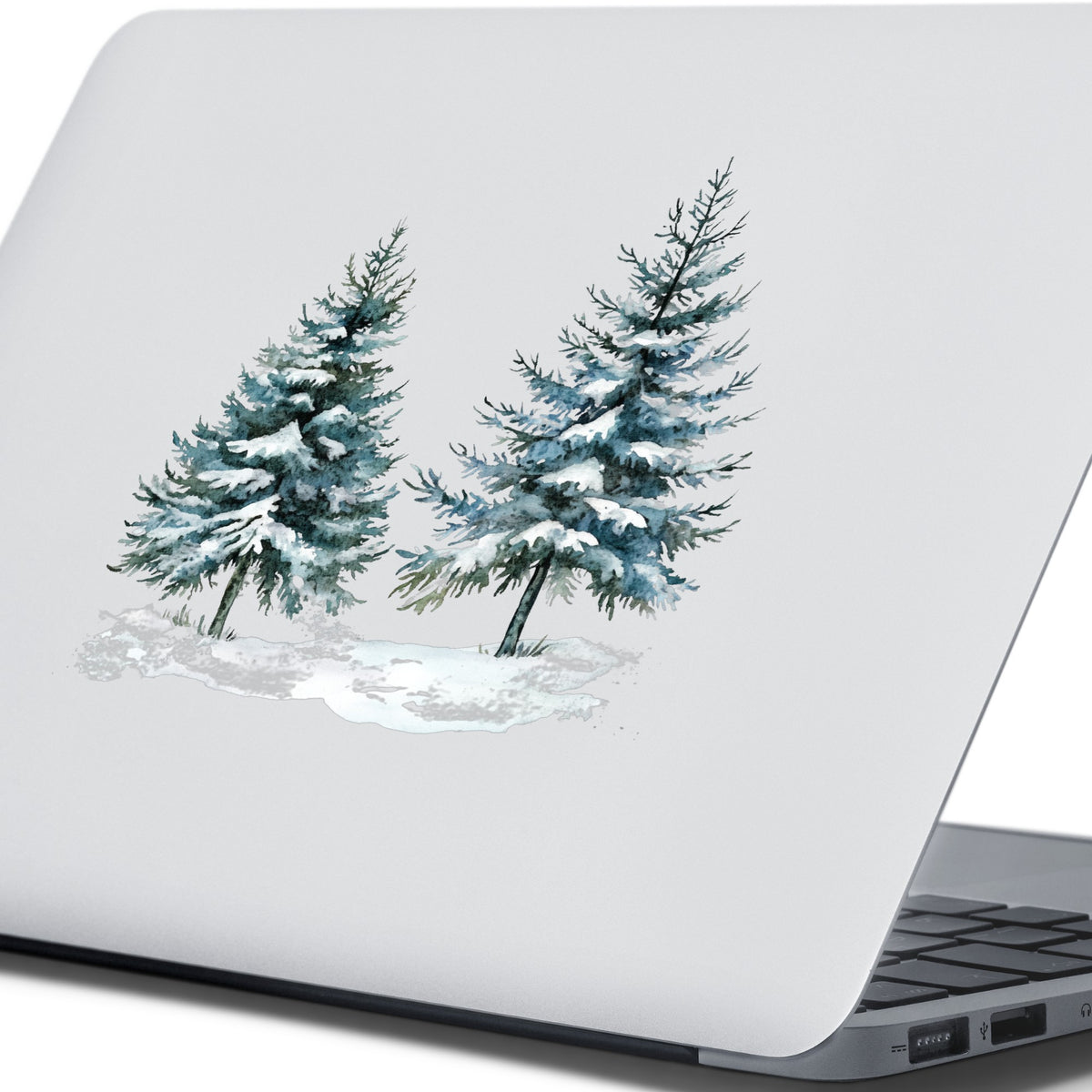 Snowy Evergreen Pair UV DTF sticker applied to a laptop