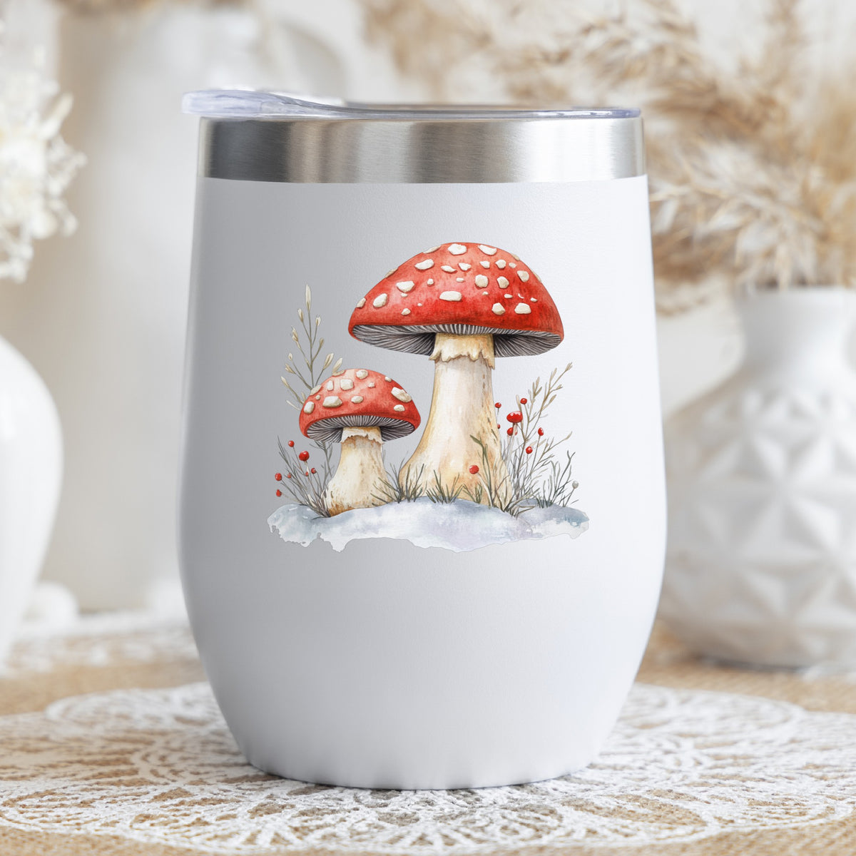 Red Mushrooms In Snow UV DTF sticker applied to a stemless wine glass