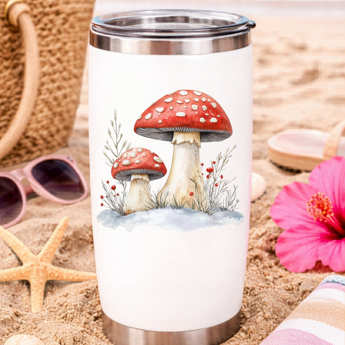 Red Mushrooms In Snow UV DTF sticker applied to a water bottle at the beach
