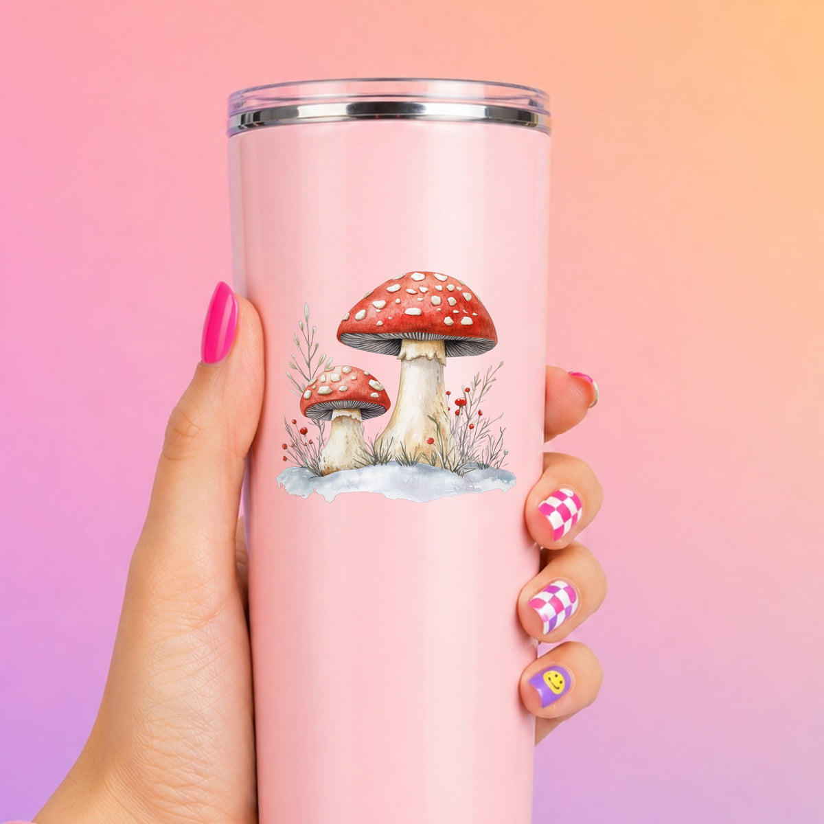 Red Mushrooms In Snow UV DTF sticker applied to a pink tumbler