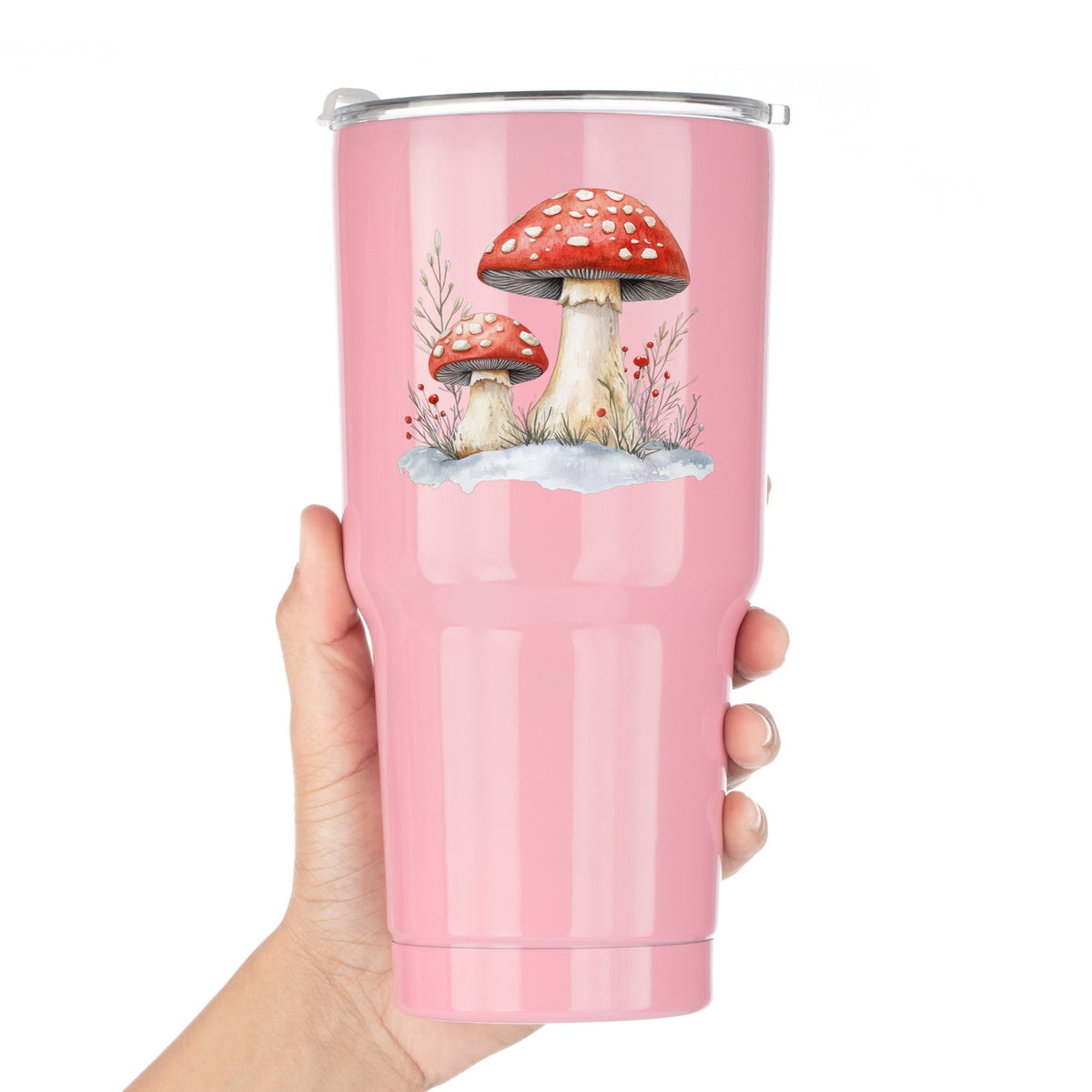 Red Mushrooms In Snow UV DTF sticker applied to a pink tumbler