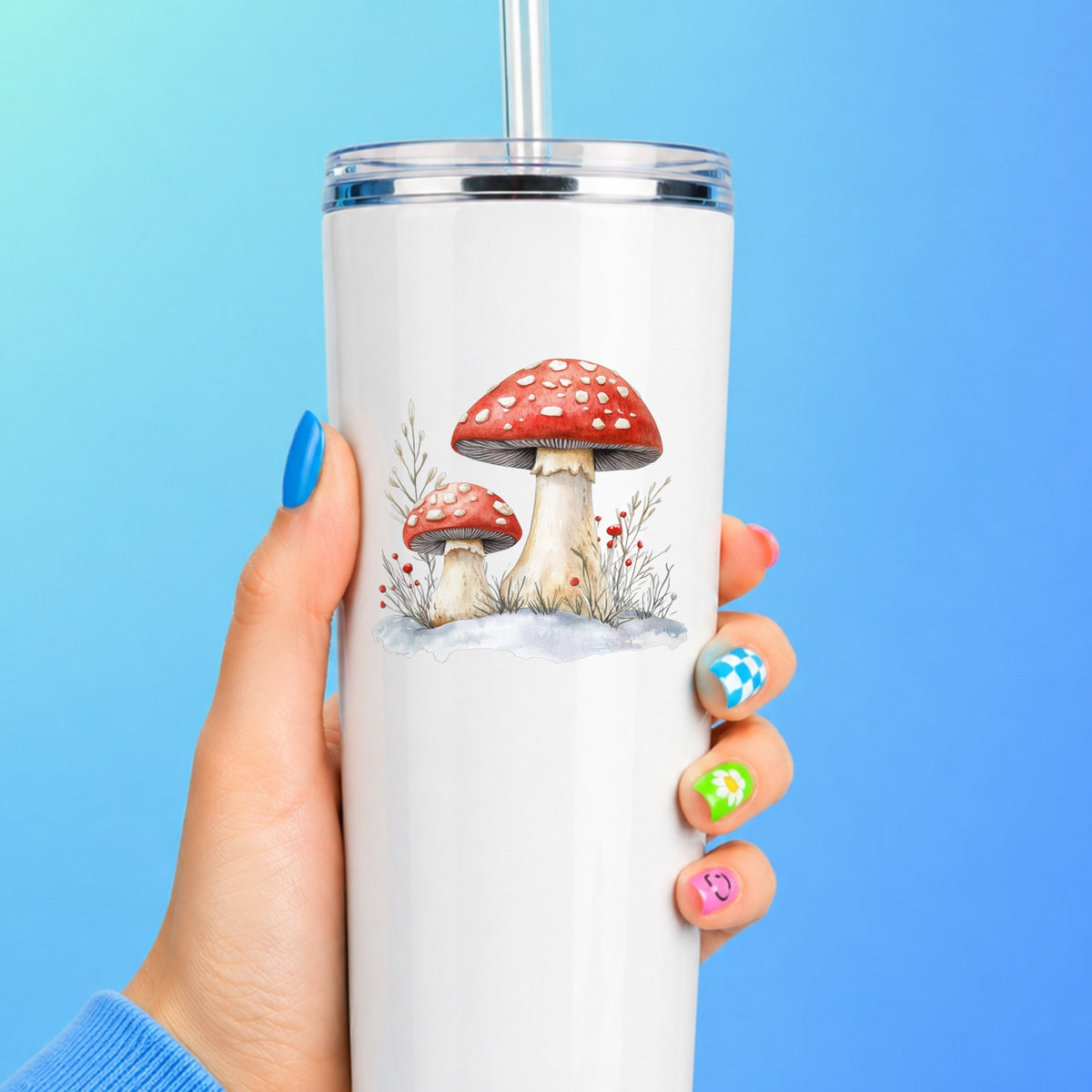 Red Mushrooms In Snow UV DTF sticker applied to a white tumbler