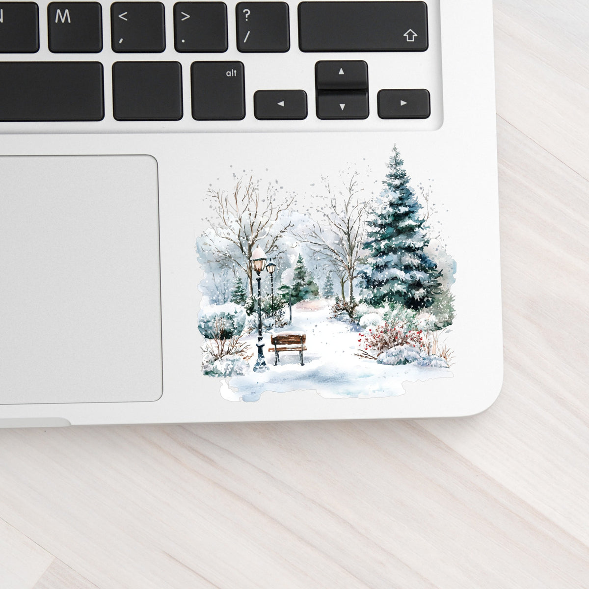 Winter Park Bench And Lamp Post UV DTF sticker applied to a laptop beside the keyboard