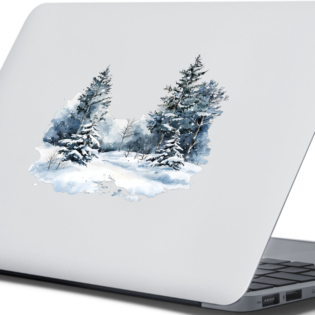 Falling Snow Pine Forest UV DTF sticker applied to a laptop