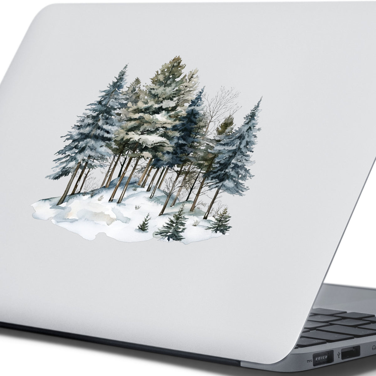 Snowy Pine Hillside UV DTF sticker applied to a laptop